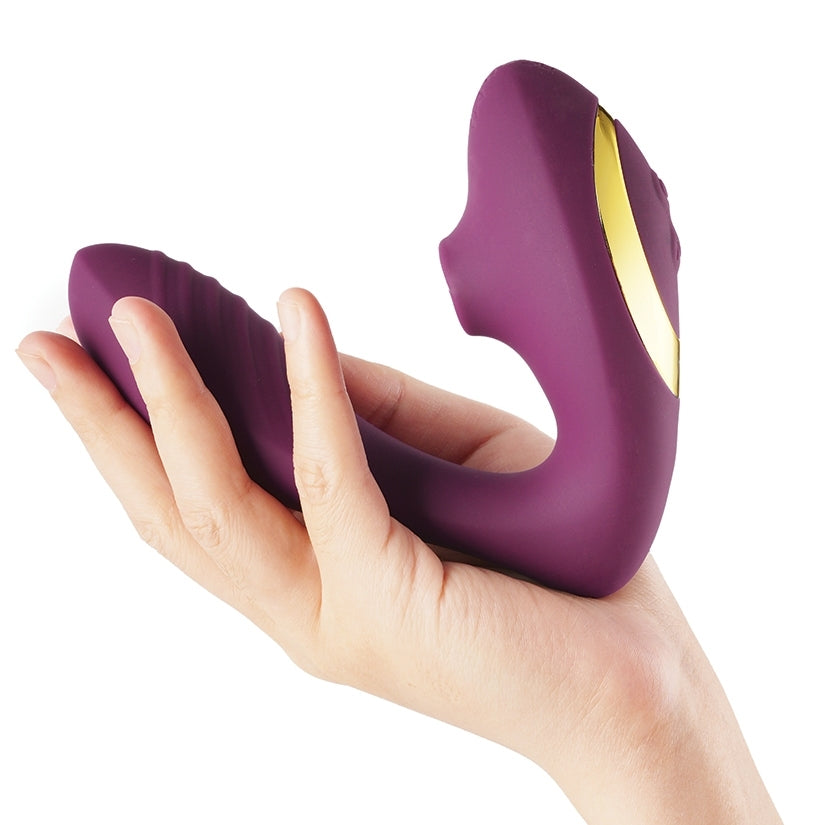 Tracy's Dog OG Clitoral Sucking Vibrator Purple held in hand showcasing its ergonomic design.