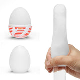 Tenga Egg Tube Disposable Masturbator Sleeve shown in hand and packaging with distinctive design.