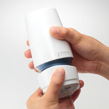 Tenga Aero Cobalt Ring Adjustable Suction Masturbator in hands demonstrating adjustable suction feature.