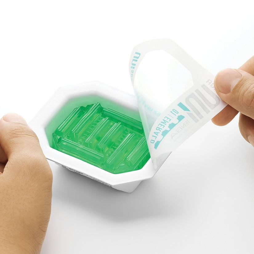 A person holding Tenga Uni Variety Pack of 4 Masturbators packaging, revealing the contents inside.