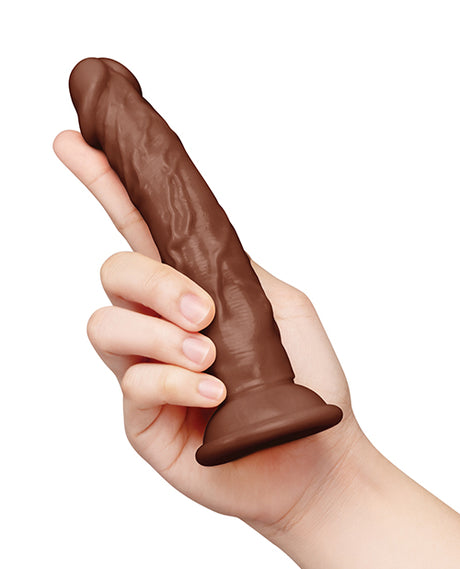 Together 6.75 Inch Realistic Suction Cup Dildo Dark held in hand, showcasing its lifelike design and body-hugging feel.