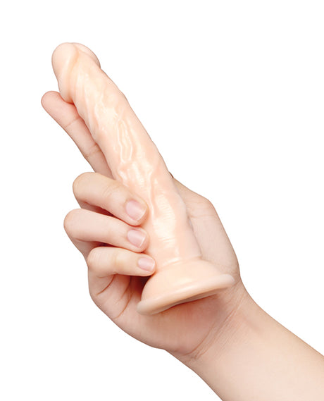Together 6.75 Inch Realistic Suction Dildo Vanilla held in a hand, showcasing its lifelike design and soft texture.