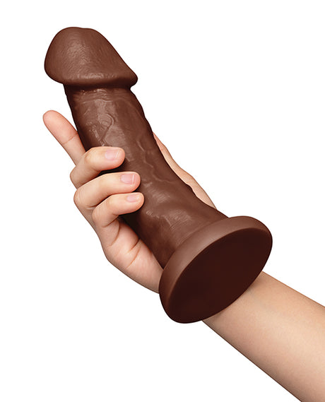Together 9 Inch Realistic Suction Base Dildo Chocolate held in hand for display.
