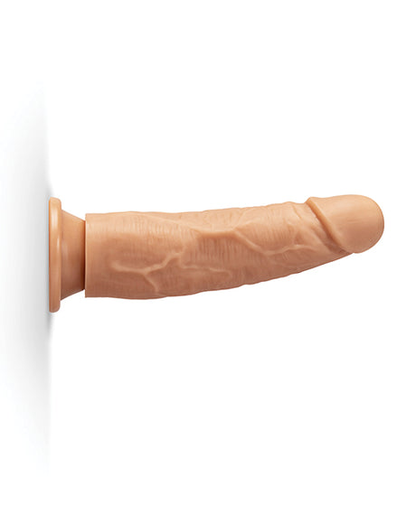 Together 7.75 Inch Realistic Dildo Suction Base Caramel displayed against a wall, showcasing its lifelike design.