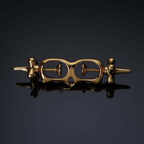 UPKO Thumb Metal Cuffs in gold, featuring a unique string mechanism for secure and discreet restraint play.