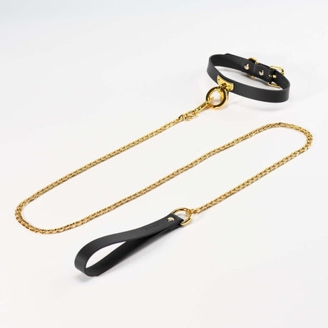 Black luxury leather collar and gold chain leash set for BDSM bondage play, elegant and stylish design for enhanced intimacy.