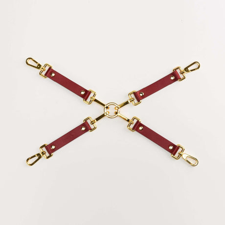 Luxury Italian leather bondage accessories set with gold hardware, designed for BDSM play and style.