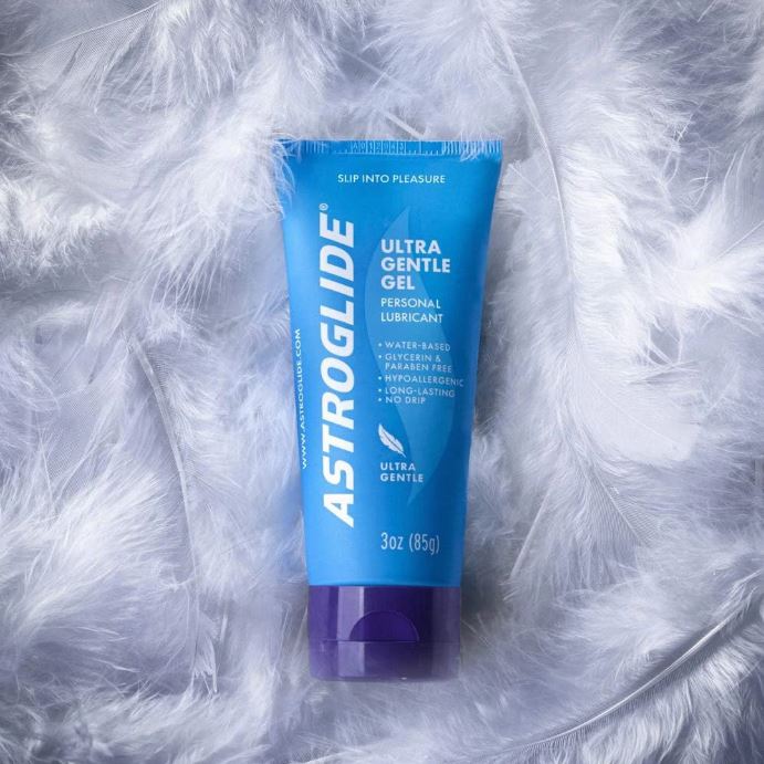 Astroglide Water Gel 3 Oz Water-Based Lubricant in a blue tube on soft feathers.