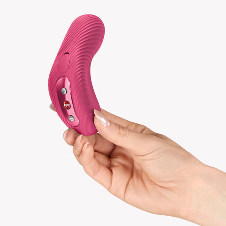 Fun Factory Laya III Lay-on Vibrator Magenta held in hand, showcasing its ergonomic design and buttons.