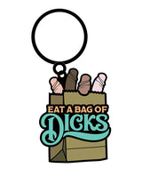 Wood Rocket Eat A Bag of Dicks Keychain Tan, humorous enamel keychain featuring a playful design.