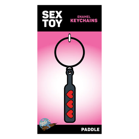 Wood Rocket Heart Paddle Enamel Keychain Black on packaging with playful design and red hearts.