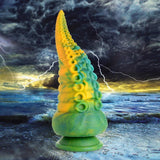 Creature Cocks Monstropus Tentacled Monster Dildo in marbled green, yellow, and blue against a stormy ocean backdrop.
