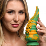Woman holding the Creature Cocks Monstropus Tentacled Monster Dildo featuring unique marbled design and tapered shape.