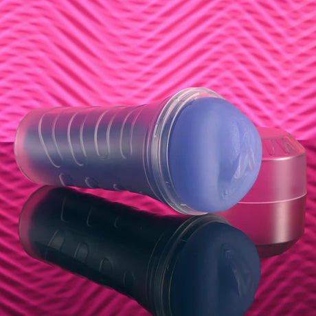 Zero Tolerance Pop On The Glow Pussy Stroker Purple on a reflective surface with a pink background.