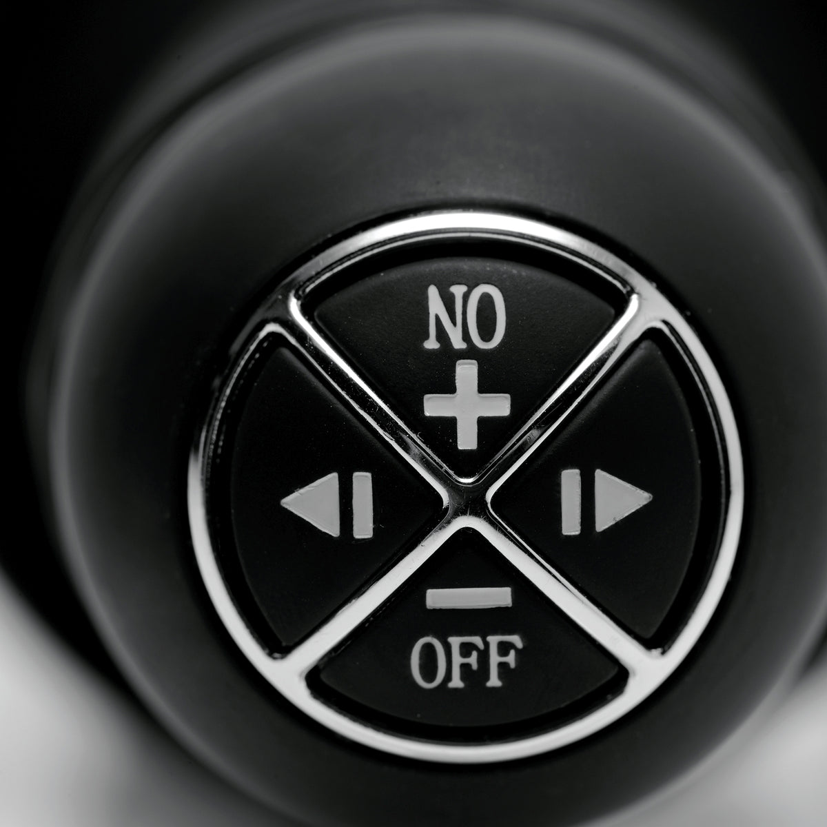 Onslaught 13 Mode XXL Vibrating Giant Dildo Thruster Flesh control button close-up for easy operation.