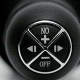 Onslaught 13 Mode XXL Vibrating Giant Dildo Thruster Flesh control button close-up for easy operation.