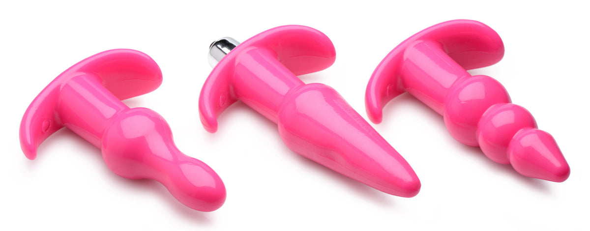 Thrill Trio Anal Plug Set Pink, three vibrant pink anal plugs with different designs for exploration and pleasure.