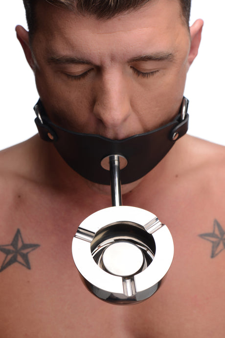 Master Series Ashtray Ball Gag Black worn by a person with a stainless steel ashtray attached.
