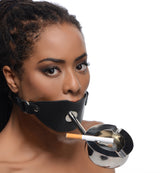 Master Series Ashtray Ball Gag Black on a model, showcasing a silicone ball gag and a stainless steel ashtray.