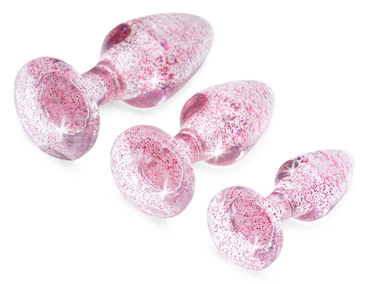 Booty Sparks Glitter Gem Anal Plug Set Pink featuring three smooth glittery pink anal plugs in graduated sizes.