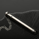 Charmed 7X Vibrating Necklace Silver on a textured surface showcasing its sleek design and chain.