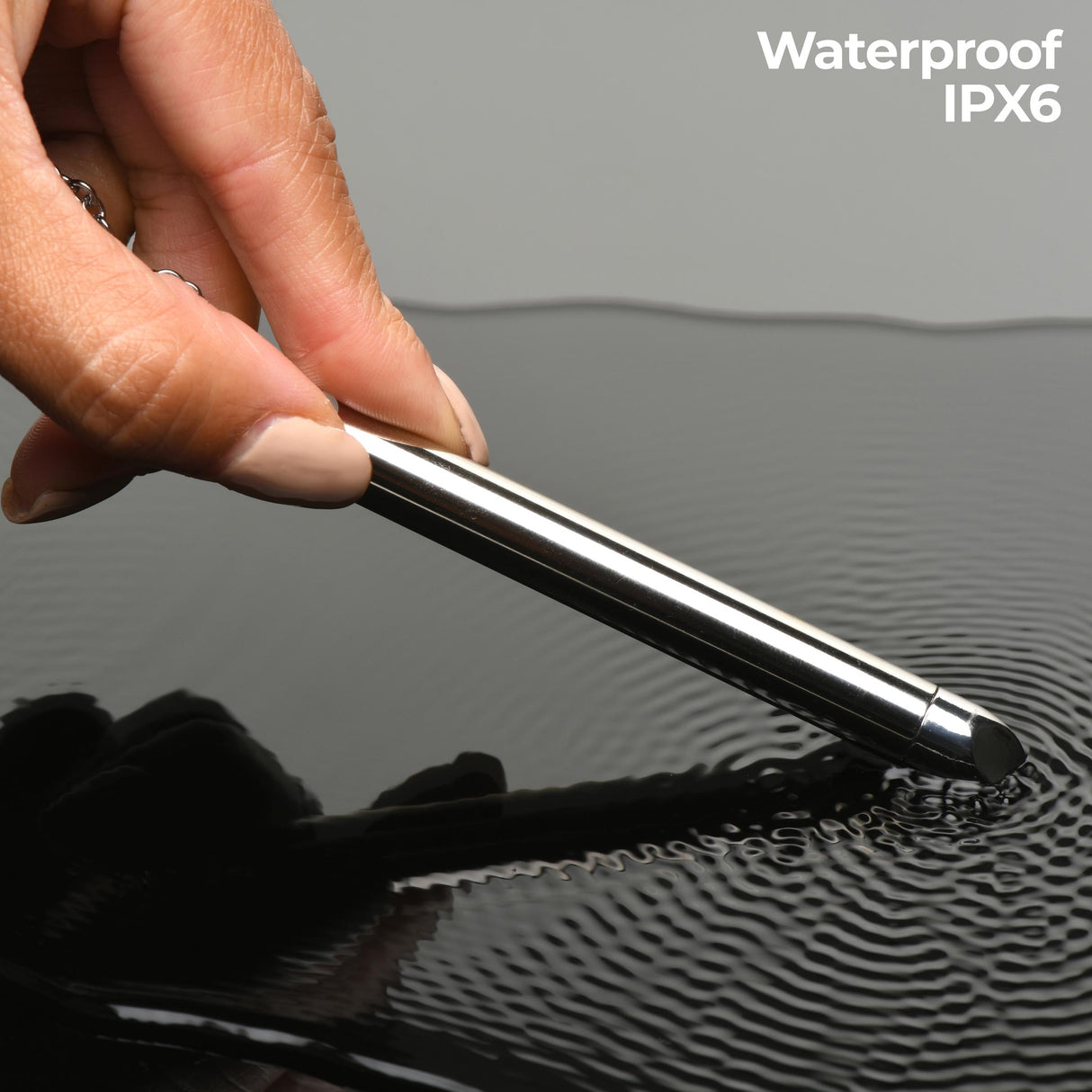 Charmed 7X Vibrating Necklace Silver being demonstrated in water, highlighting its waterproof IPX6 feature.