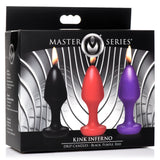 Master Series Kink Inferno Drip Candles in black, red, and purple packaging with flames.