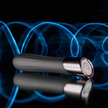 Evolved Back In Black Rechargeable Silicone Bullet on a reflective surface with blue light swirls in the background.