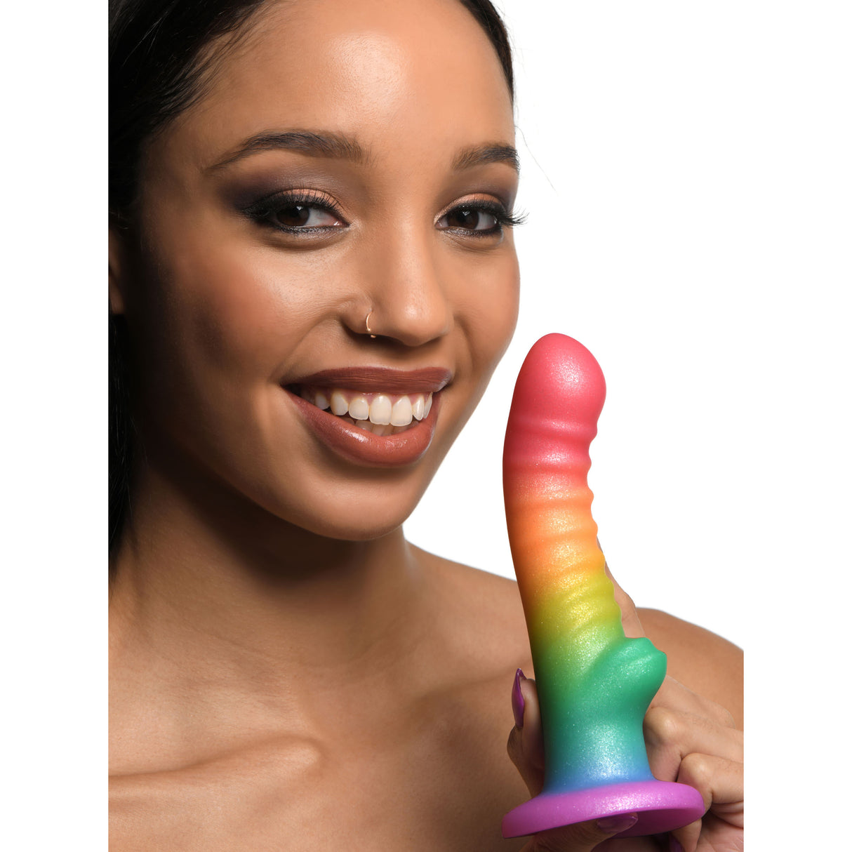 Simply Sweet Ribbed Rainbow Silicone Dildo held by a smiling woman showcasing its vibrant colors and ribbed texture.