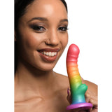 Simply Sweet Ribbed Rainbow Silicone Dildo held by a smiling woman showcasing its vibrant colors and ribbed texture.