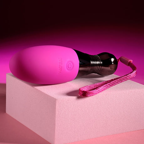 Selopa Companion Rechargeable Silicone Egg Pink on display with its chrome-finished handle and pink silicone surface.