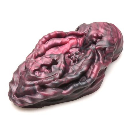 Alien vulva silicone grinder in red and black, designed for pleasurable stimulation with textured grooves.