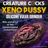 Alien-inspired silicone vulva grinder in red and black for unique pleasure experiences.