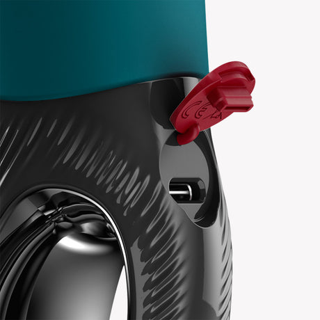 Close-up of Fun Factory Manta Vibrating Stroker Green showing the charging port and ergonomic design features.