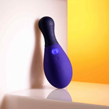 Selopa Egg Me On Remote Control Egg Vibrator Purple resting against a wall with a colorful background.