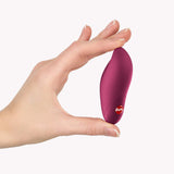 Fun Factory Charme Rechargeable Bullet Vibrator Wine Red held in hand for scale and portability demonstration.