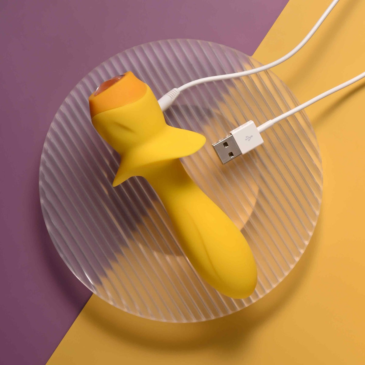 Selopa Mellow Yellow Silicone Vibrating Plug Yellow on a round plate with USB charging cable.