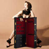 Luxury bondage storage trunk with red velvet interior, showing compartments for BDSM tools and a stylish model.