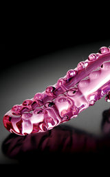Icicles No 24 Hand Blown Glass Massager Pink with unique detailing on a reflective surface