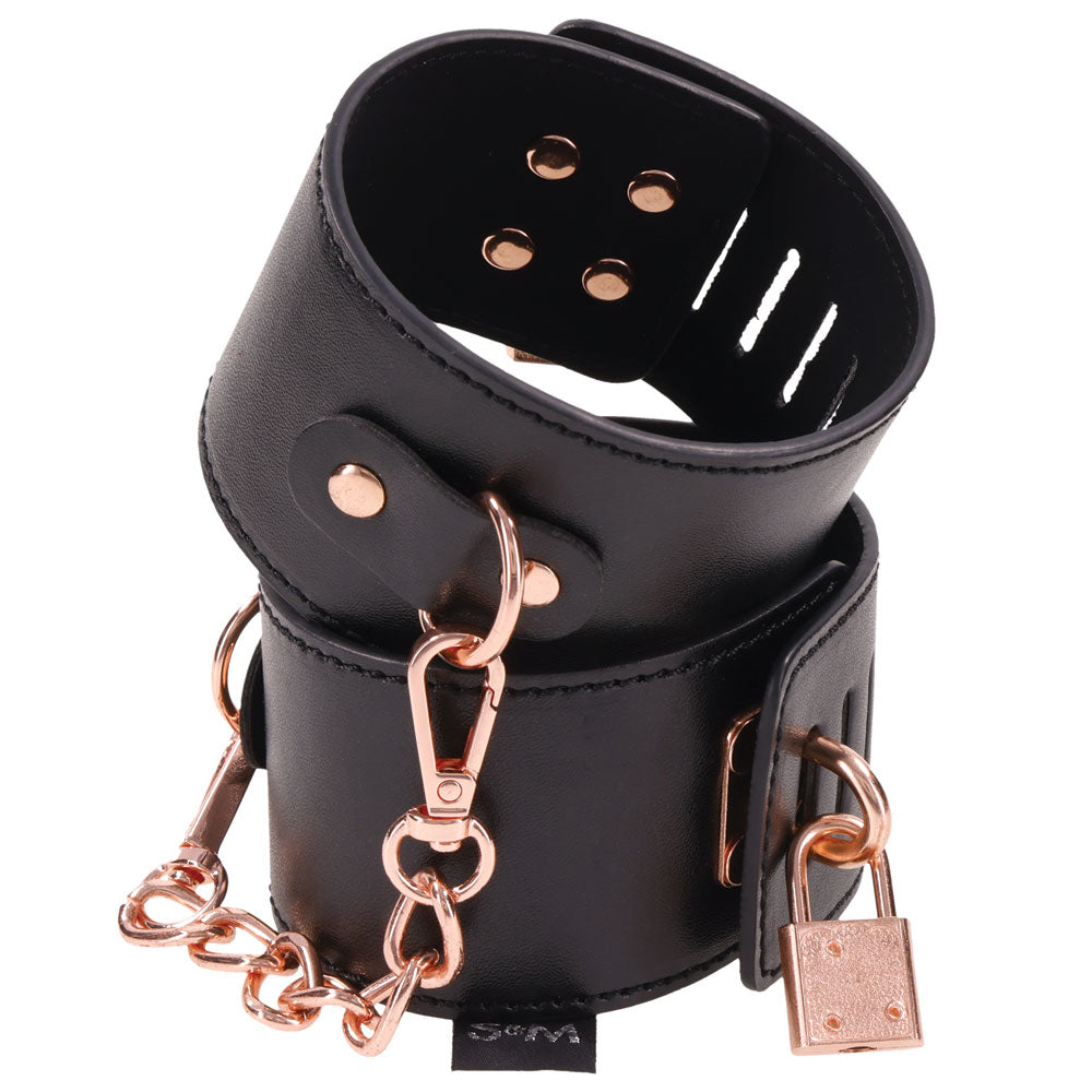 Sex and Mischief Brat Locking Cuffs Rose Gold Black with black vegan leather and rose gold accents.