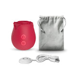 Sweet Dreams Rose True Suction Clitoral Stimulator in red with charging cable and storage pouch.