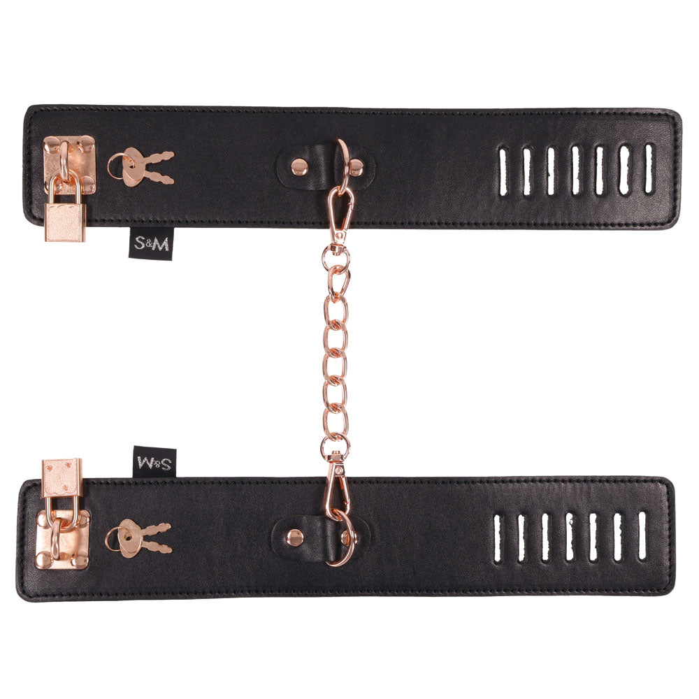 Sex and Mischief Brat Locking Cuffs Rose Gold Black featuring sleek black vegan leather and captivating rose gold accents.
