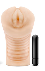 M Elite Soft and Wet Annabella Pussy Stroker Beige with included bullet vibrator next to it.