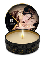 Shunga Mini Massage Candle Excitation Intoxicating Chocolate 1 Oz with flame, depicting romantic design on lid.